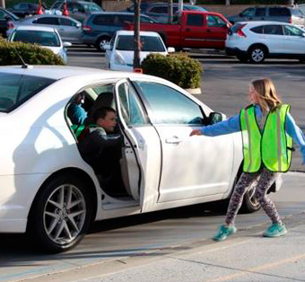 student helping another student exit their car