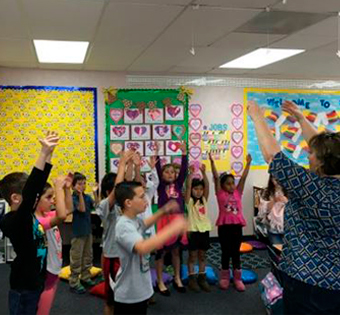 students cheering in their classroom